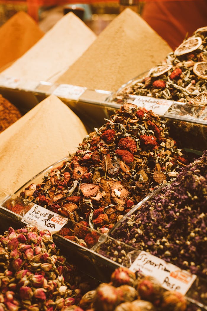 Colorful spices and dried teas artfully displayed in a local market stall.
